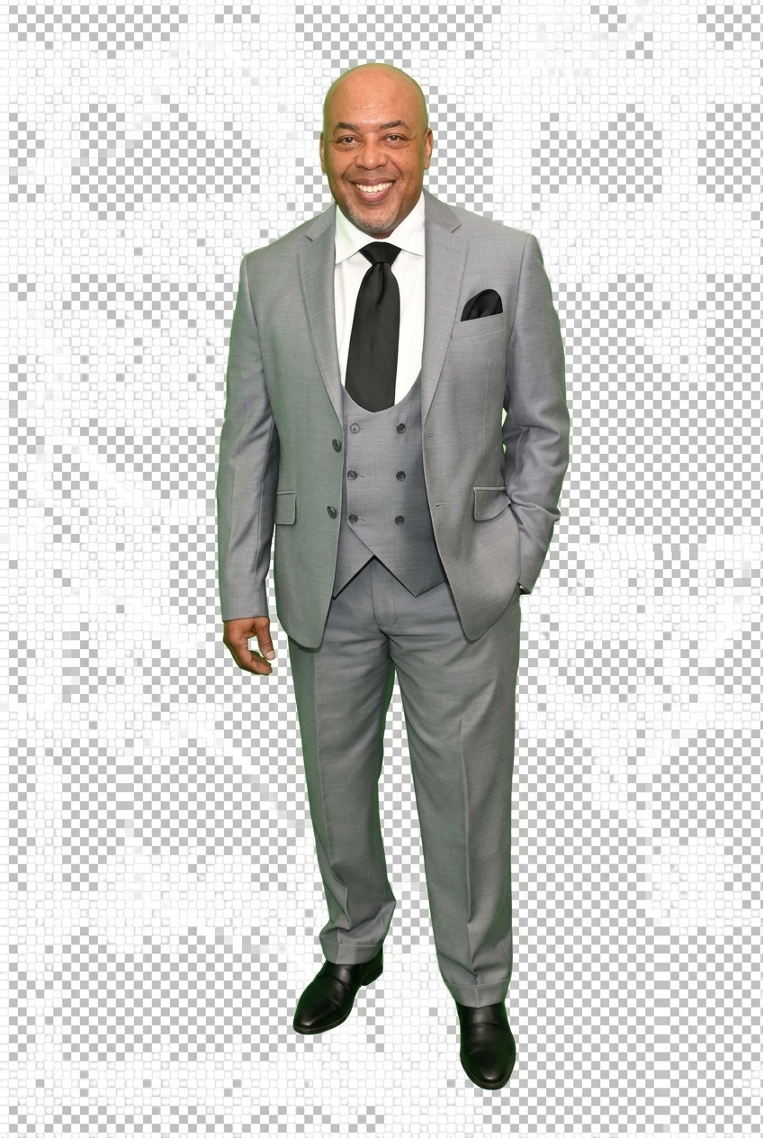 Roderick Coleman smiling in a light gray three-piece suit